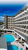 a large apartment building with a swimming pool at Monte Carlo Hotel in Alanya
