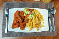un plato de comida con papas fritas y ensalada en Heri Heights Hotel Apartments, SureStay Collection by Best Western, en Nairobi