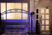 a bed with blue lights in front of a door at Maple in Wujie
