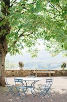 a picnic table and two chairs under a tree at Château de Pierreclos in Pierreclos