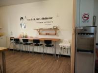 a kitchen with a table and chairs and a refrigerator at Jia Mei Fa Homestay in Taitung City