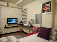 a living room with a couch and a tv at Jia Mei Fa Homestay in Taitung City