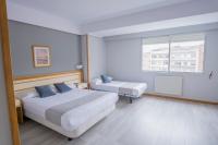 Posteľ alebo postele v izbe v ubytovaní Hotel Alda Boiro