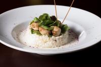 a plate of food with rice and meatballs and greens at Khabti Grand Hotel in Qal'at Bishah
