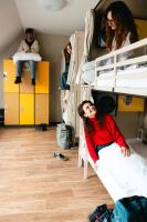 a group of people in a dorm room with bunk beds at Wombat&#39;s City Hostel Vienna Naschmarkt in Vienna