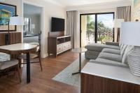 a living room with a couch and a table at The Atlantic Suites on the Ave in Delray Beach