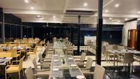 a dining room with tables and chairs and tablesearcher at Mainland Resorts & Spa by Kolaahalam in Yercaud