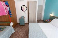 A bed or beds in a room at G House Rimini Spiaggia