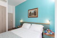A bed or beds in a room at G House Rimini Spiaggia