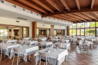 a banquet hall with white tables and chairs at VOI Arenella Resort in Arenella