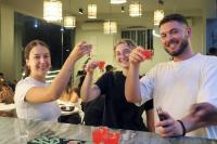 a group of people holding up their drinks at Gspot Hostels & Love Triangles Pizzeria in Lisbon