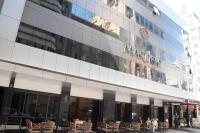 a building with tables and chairs in front of it at Marlight Boutique Hotel in İzmir