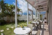 a patio with tables and chairs and a view of the ocean at Taitung Quality B&amp;B in Taitung City