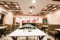 a restaurant with tables and chairs in a room at Desert Dream Royal Camp & Pool in Jaisalmer