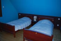 two beds in a room with a blue wall at la grange in Wintzenheim