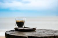 a glass of coffee sitting on top of a table at Lanta Riviera Beach Resort in Ko Lanta