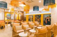 a restaurant with yellow walls and tables and chairs at Bikube Lyon in Lyon