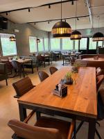 a dining room with a large wooden table and chairs at 20A Hoofdweg in Midwolda