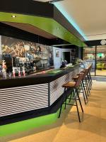 a bar in a restaurant with chairs and a counter at 20A Hoofdweg in Midwolda