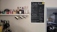 eine Tafel mit einer Getränkekarte an einer Wand in der Unterkunft Trevassack Holidays in Helston