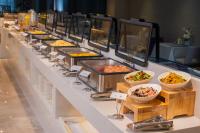 a buffet line with bowls of food and other foods at Lavande Hotel Xi'an Bell Tower Muslim Street North Street Subway in Xi'an