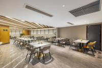 a restaurant with tables and chairs in a room at Atour Hotel Chongqing North Railway Station in Chongqing
