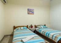 A bed or beds in a room at Borsalino Studios & Apartments