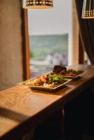 two plates of food on a wooden table at Hotel Kaķītis in Sigulda