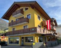 a large yellow building with wooden balconies on it at Au 10 in St. Wolfgang