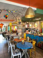 a restaurant with tables and chairs and a counter at Boutique Hotel Casa Art in Oreshak