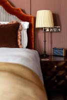 a bedroom with a bed and a lamp on a nightstand at The Brewers Inn in London