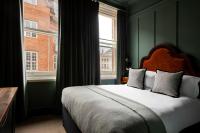 a bedroom with a large bed and a window at The Brewers Inn in London