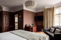 a bedroom with a bed and a couch and a chair at The Brewers Inn in London