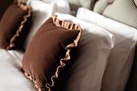 a bed with two brown pillows on it at The Brewers Inn in London