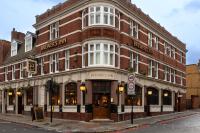 a large brick building on the corner of a street at The Brewers Inn in London