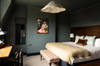 a bedroom with a bed and a desk and a mirror at The Brewers Inn in London