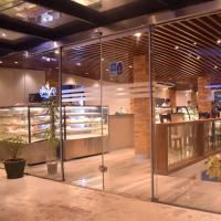 a lobby of a store with glass doors and flowers at Heritage Grand - Badulla in Badulla