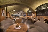 a restaurant with tables and chairs and a menu at Wilson Palace by LOFT in Bratislava