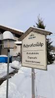 un cartello nella neve davanti a una casa di FeWo Allgäuerle1604 mit Hallenbad, Sauna und WLAN a Missen-Wilhams