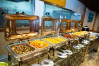 a row of trays of food on a buffet line at Heritage Grand - Badulla in Badulla