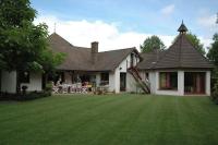 a house with a green lawn in front of it at La Coulonnière in Wismes