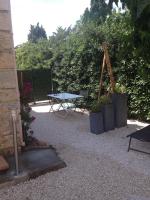 a patio with a table and potted plants at Les Lones avec jardin in Six-Fours-les-Plages