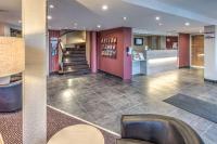 a lobby with purple walls and a staircase at Contact Hôtel Astréa Nevers Nord et son restaurant la Nouvelle Table in Varennes Vauzelles