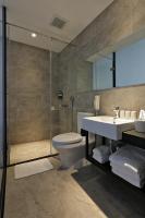 a bathroom with a toilet and a sink and a shower at Miller Inn in Taichung