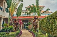 a house with trees and plants in front of it at Guest Wharf - Côte Sauvage in Pointe-Noire