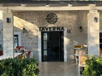 a restaurant entrance with a sign that reads taverna at Portico Djenovici in Ðenovići