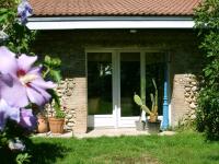 a front door of a house with potted plants at La Ferme de Thoudiere in Saint-Étienne-de-Saint-Geoirs