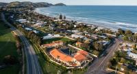 an aerial view of a town next to the ocean at Ocean Beach Wainui in Gisborne