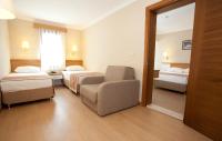 Postel nebo postele na pokoji v ubytování Aes Club Hotel