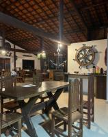 una sala da pranzo con un grande tavolo in legno e sedie di Chalé Estância do Coruja a Salesópolis